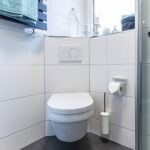 Bathroom with Dual Flush Mounted Corner Toilet